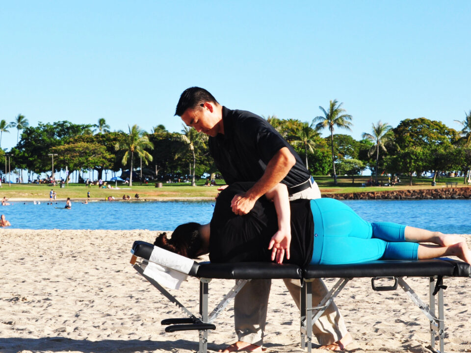 Dr. Shaun giving an adjustment on the beach.