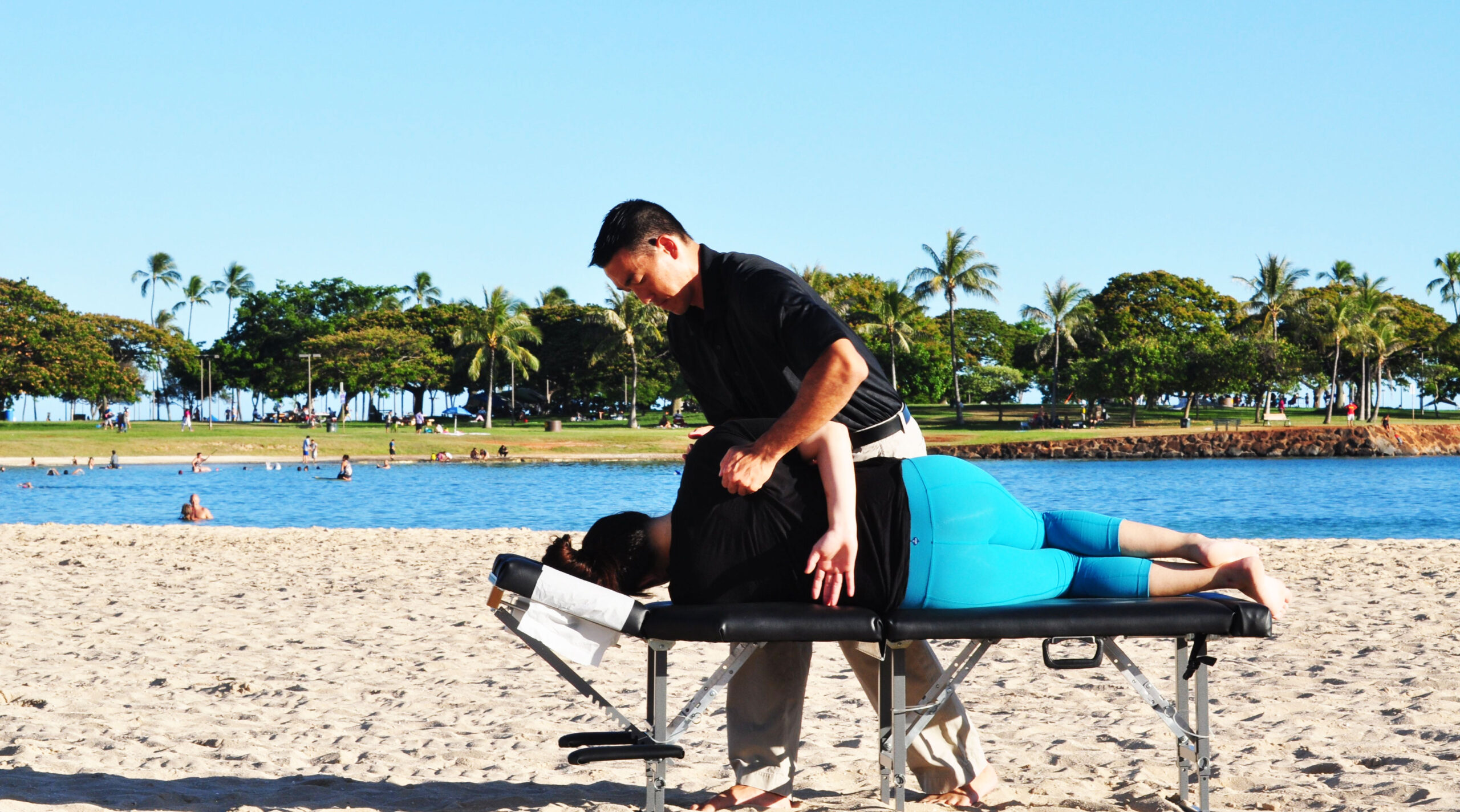 Dr. Shaun giving an adjustment on the beach.