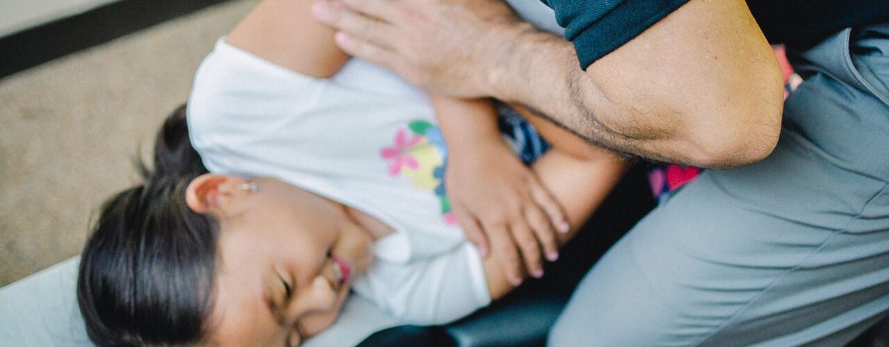 Dr. Shaun giving a child an adjustment