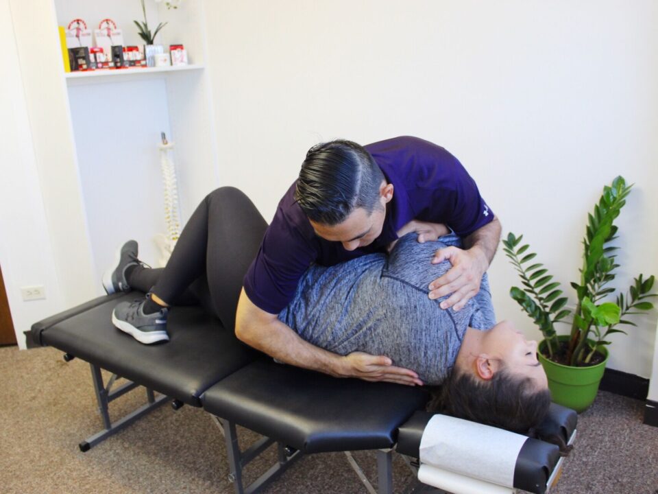 Dr. Shaun Ohira, working on patient's back.