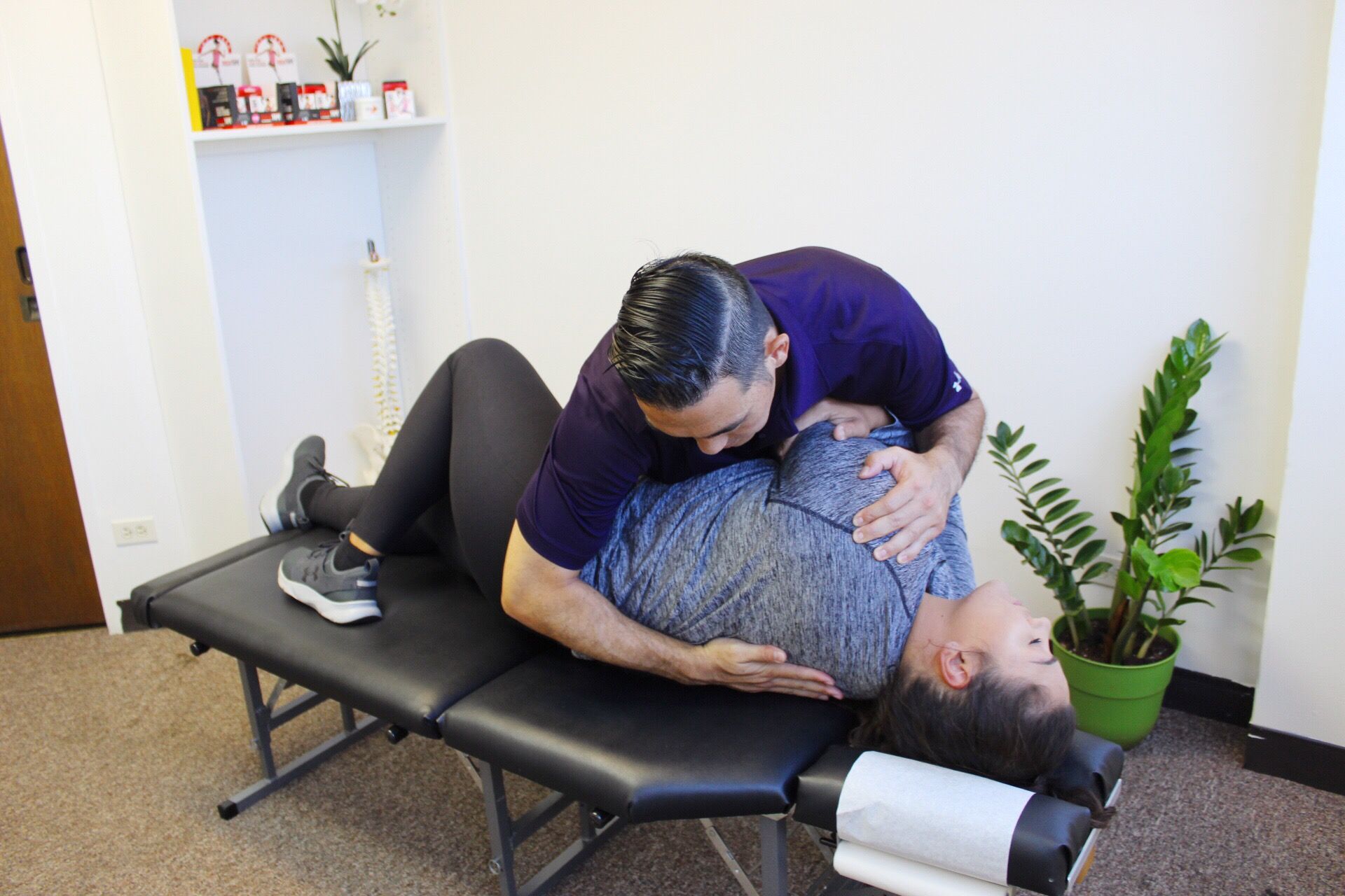 Dr. Shaun Ohira, working on patient's back.