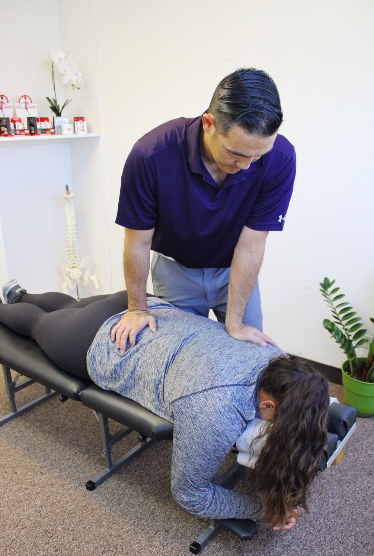 Dr. Shaun Ohira, working on patient's back.