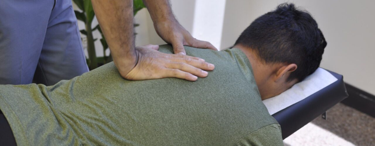 Dr. Shaun adjusting patient's neck.