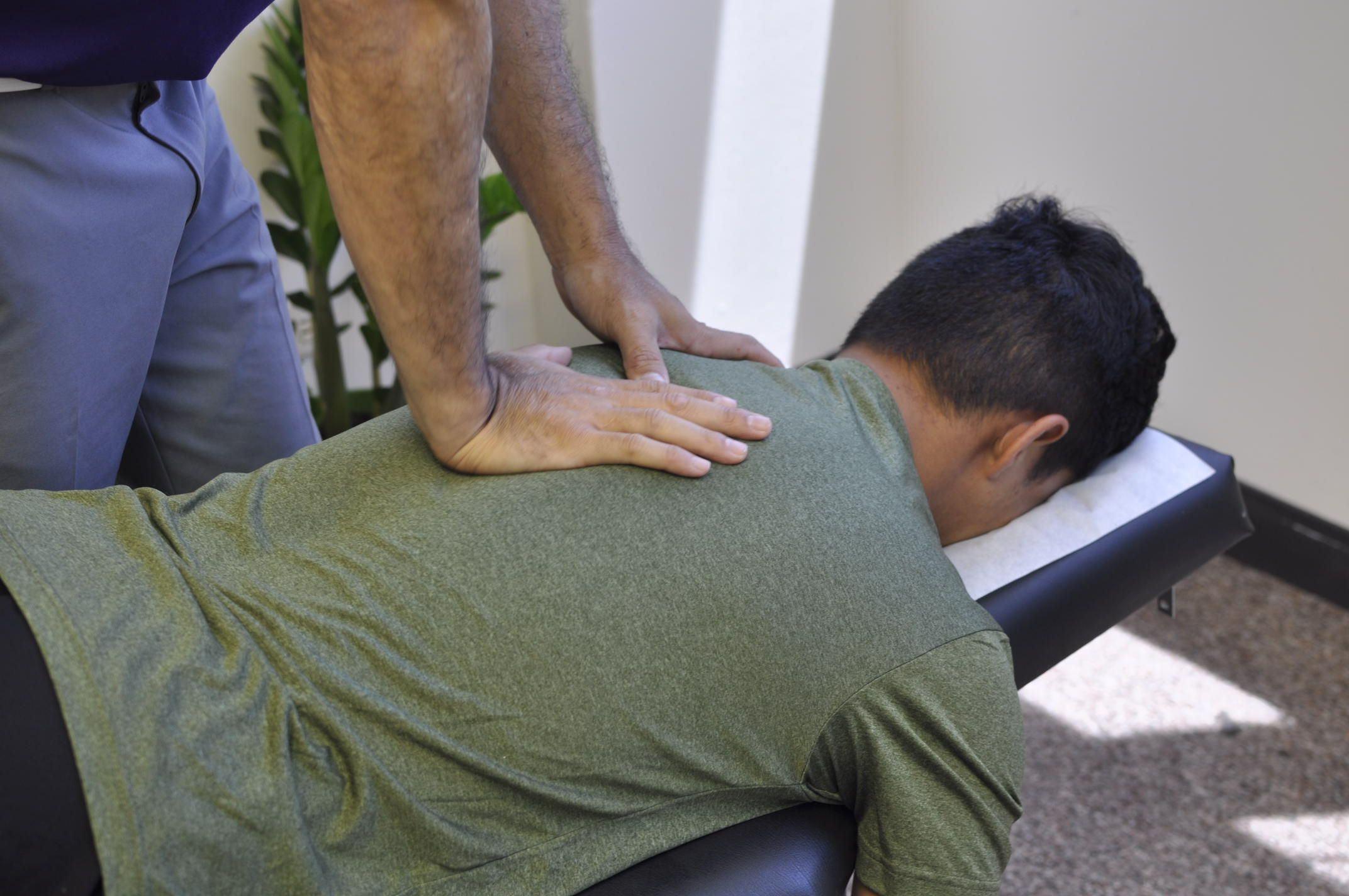 Dr. Shaun adjusting patient's neck.