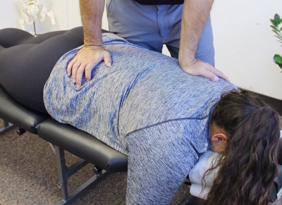Dr. Shaun Ohira, working on patient's back.