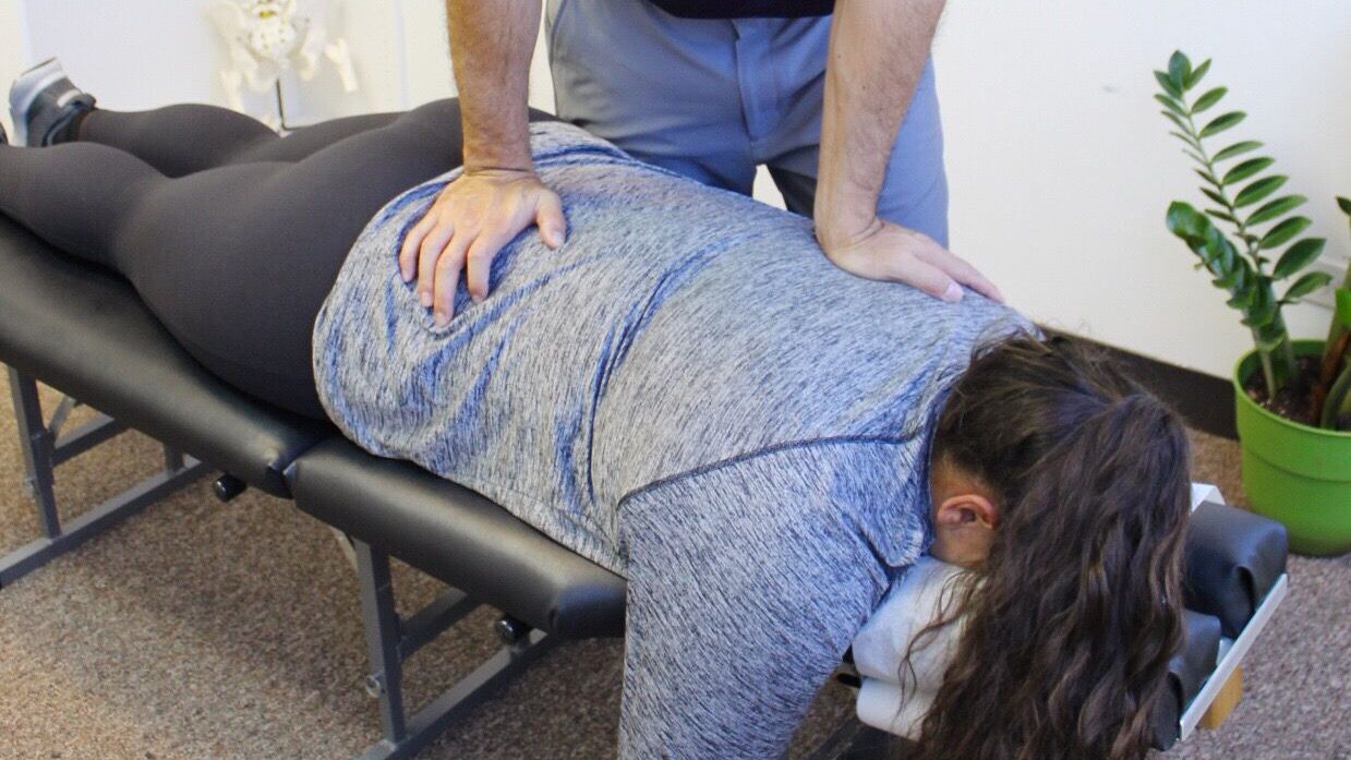 Dr. Shaun Ohira, working on patient's back.