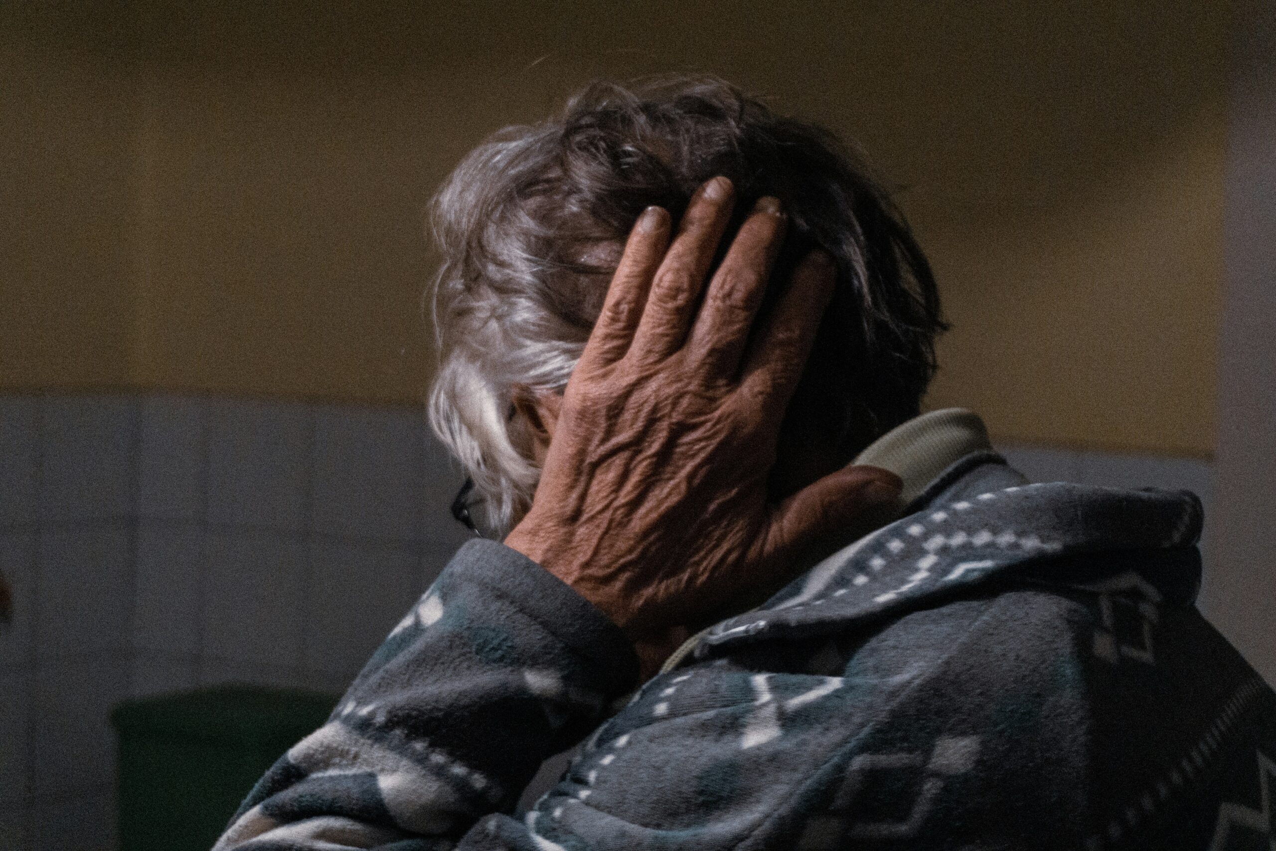 A lady holding her head in pain