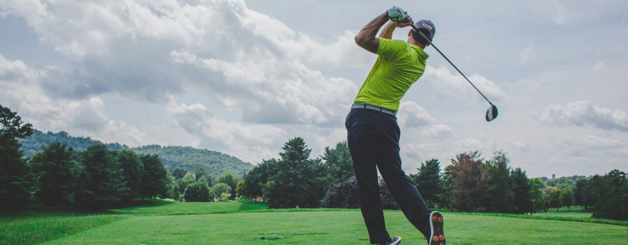 A golfer mid drive