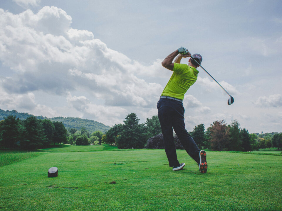 A golfer mid drive