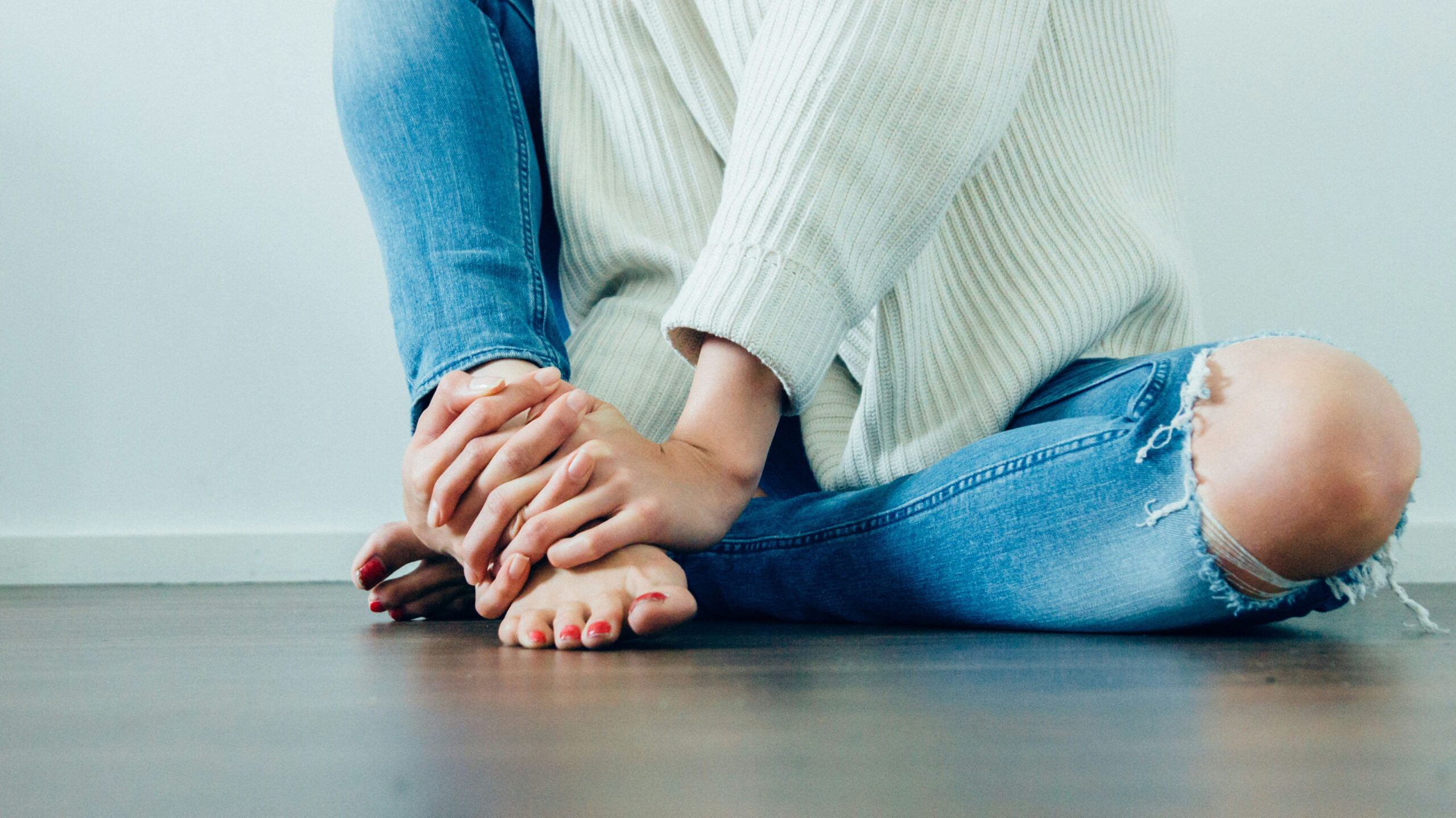 A lady holding her foot in pain
