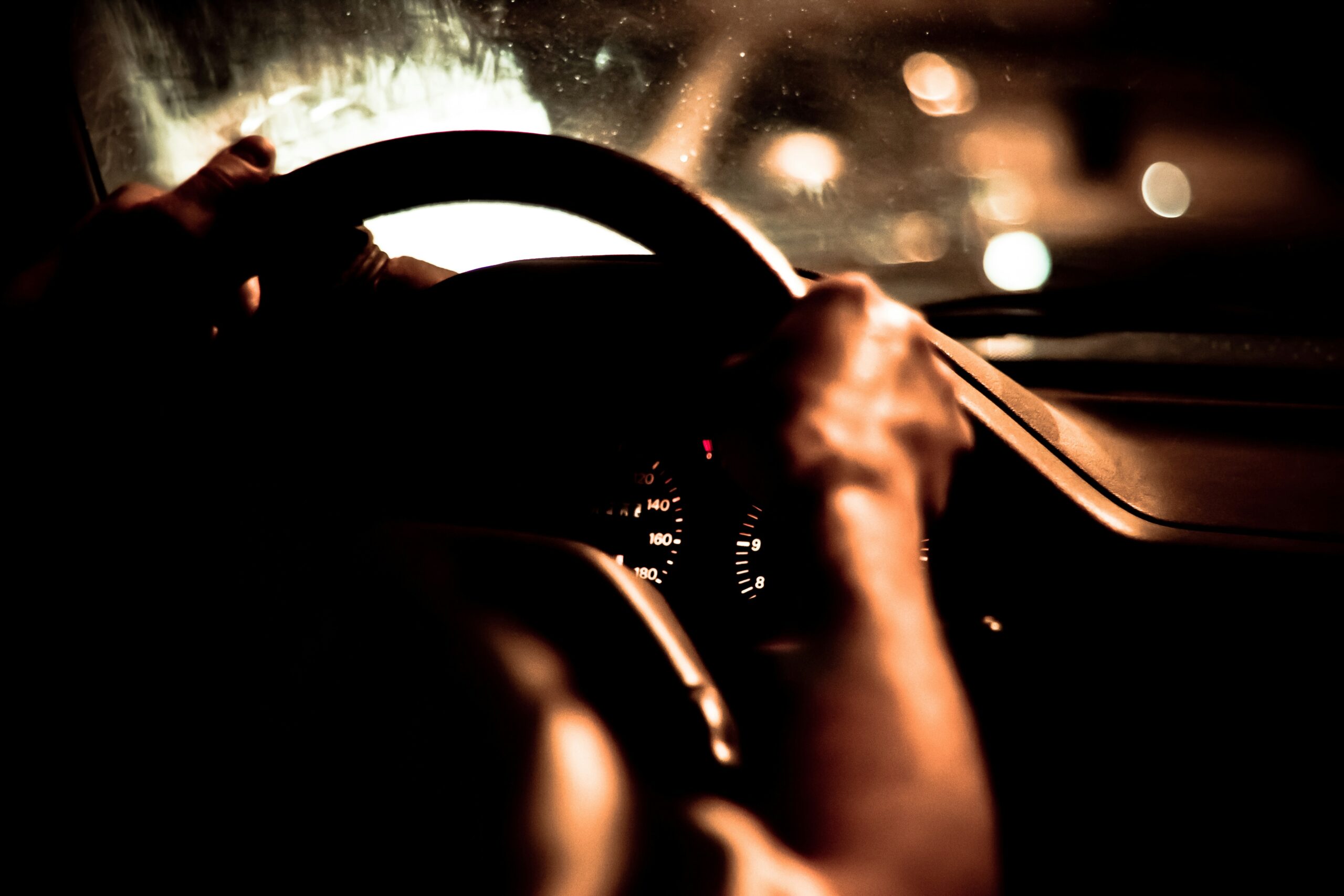 Someone driving a car at night