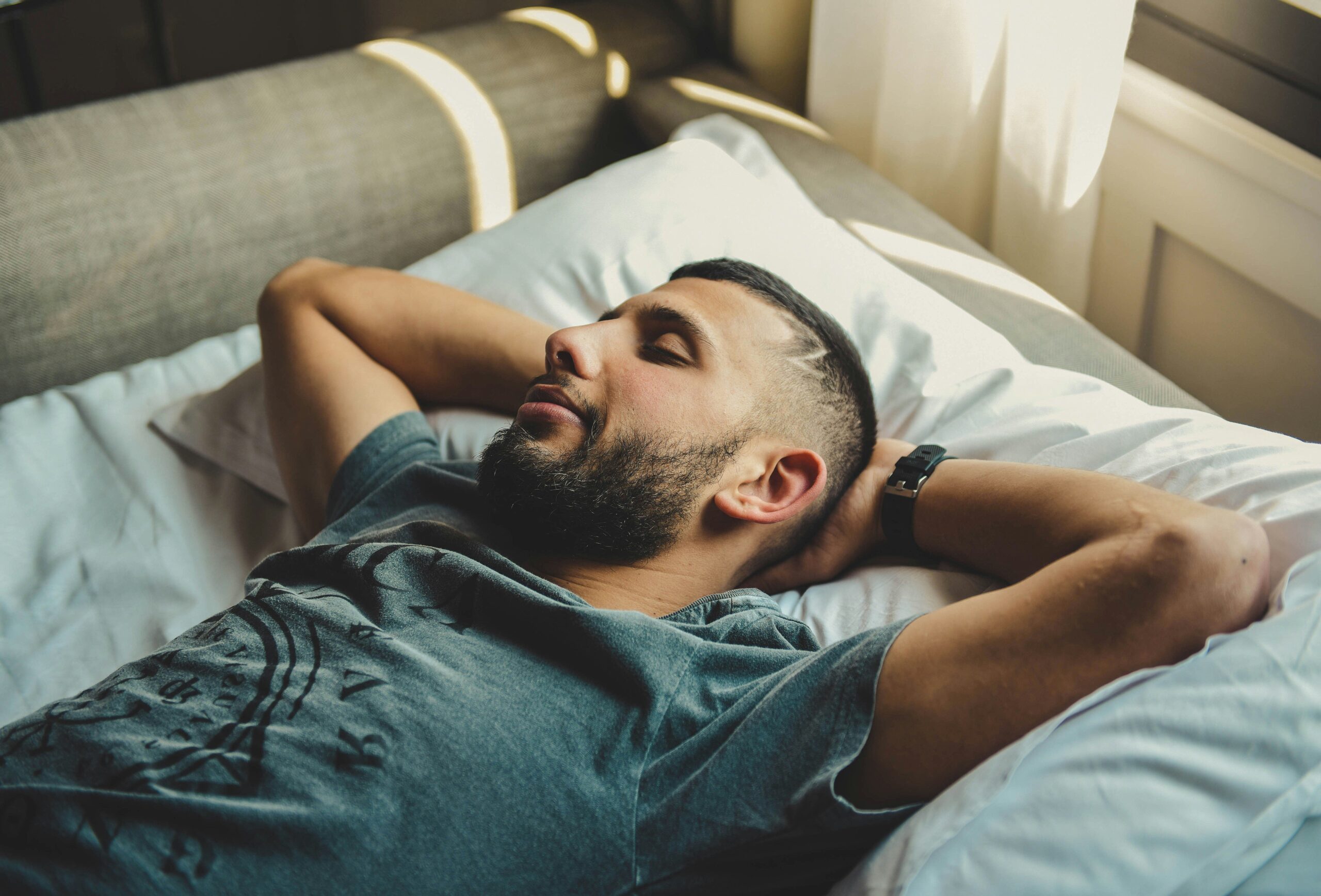 A man looking relaxed in bed